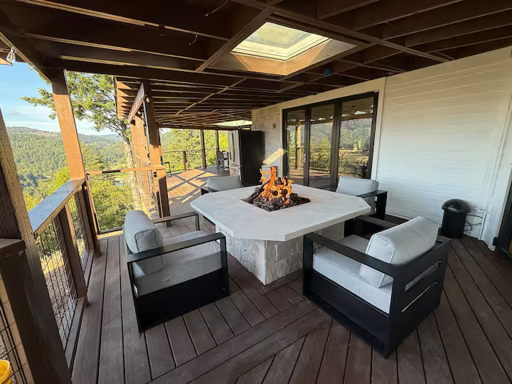 Cliff House covered deck with fire table and forest views
