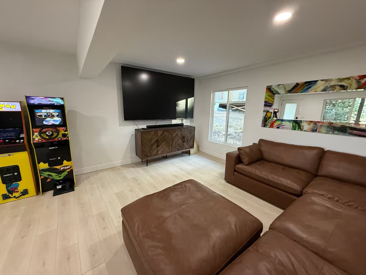 Cliff House game room with arcade cabinets and leather seating