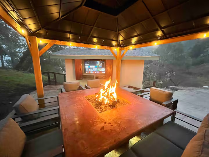 Covered outdoor gazebo with fire pit and seating
