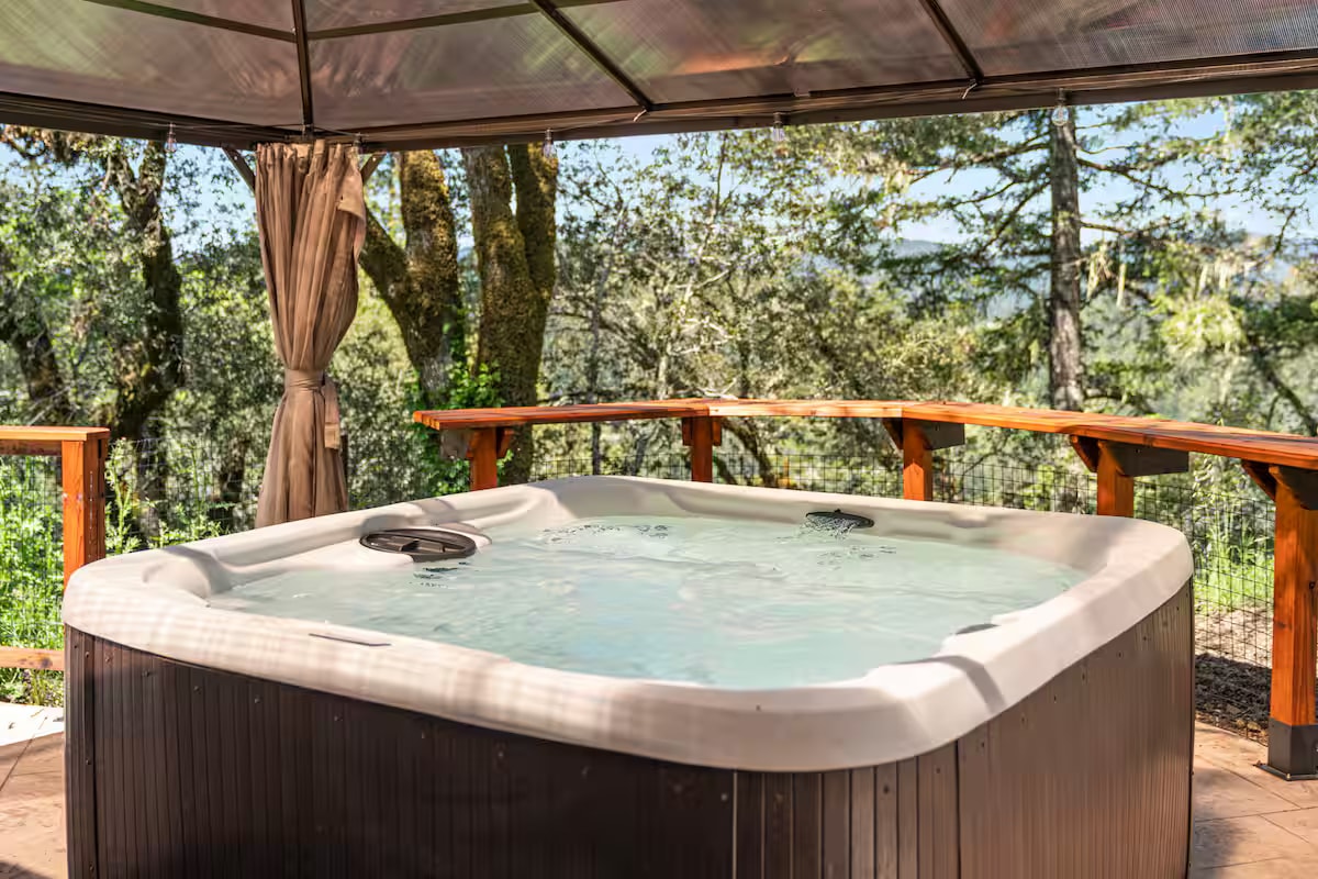 Hobbit House hot tub on a wooded deck
