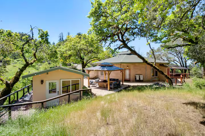 Hobbit House hillside home among mature trees